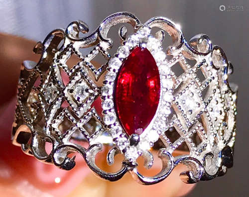 A PLATINUM CAST RUBY DIAMOND RING