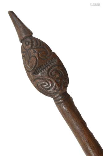 An early 20th century Maori staff with carved decoration to the flattened oval tip and with plain
