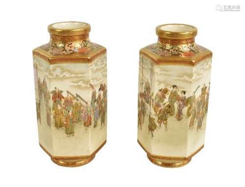 A pair of Japanese Meiji period hexagonal Satsuma vases decorated with procession scenes beneath