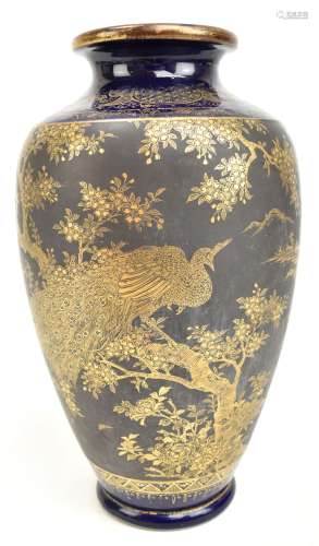 A Japanese Satsuma Meiji period vase, decorated in gilt with a peacock perching on a branch,