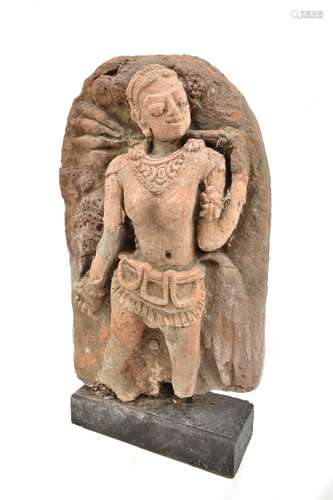 A Javanese carved fragment of arched form decorated with a female figure, height 46cm, mounted on