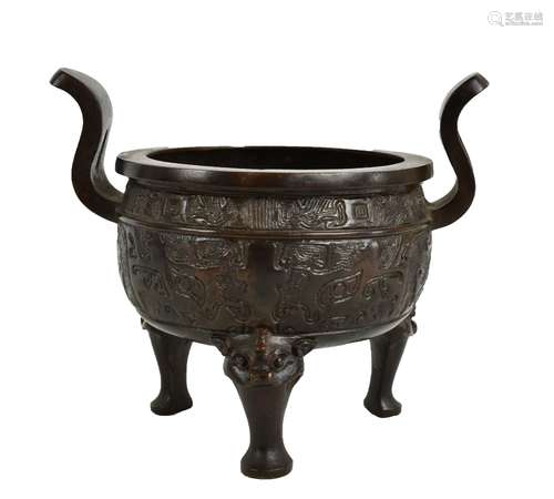 A 19th century Chinese bronze censer with twin raised handles and impressed decoration, on three