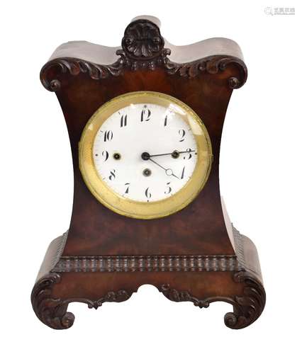 A William IV mahogany mantel clock, with carved detail surrounding the circular enamelled dial set