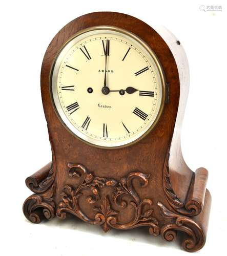 ADAMS OF LONDON; a 19th century pollard oak mantel clock, the circular dial set Roman numerals, with