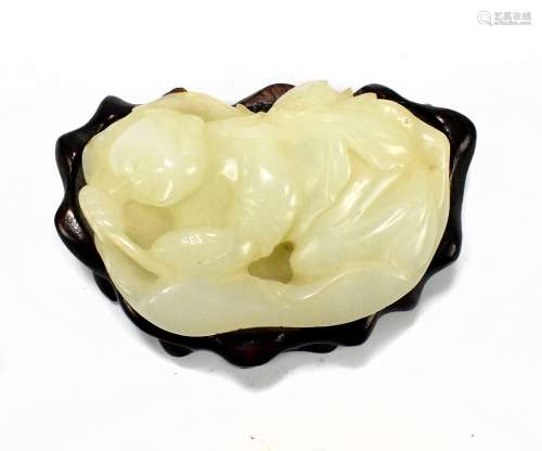 A Chinese jade carving depicting recumbent poet or scholar, probably Li Bai, holding citrus fruit,