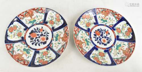 A pair of Japanese Meiji period Imari porcelain circular chargers painted with panels of birds and