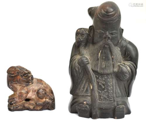 An 19th century Chinese carved soapstone figure of a chi chi, length 4.25cm, and an unusual black