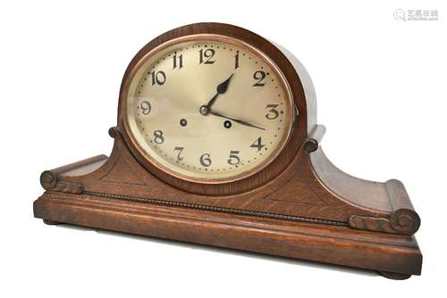 JUNGHANS OF WURTTENBERG; an early 20th century oak cased mantel clock with carved and beaded detail,