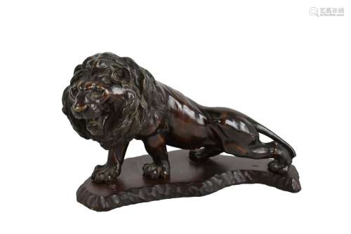 A large Japanese Meiji period bronze lion mounted on an adzed wooden base, signed to plaque to
