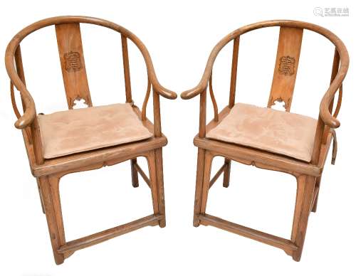 A pair of northern Chinese elm yoke back chairs with caned seats, height 100cm (2).