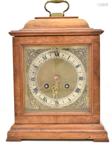 A 20th century walnut cased mantel clock, the brass face with silvered dial with Roman numerals, the