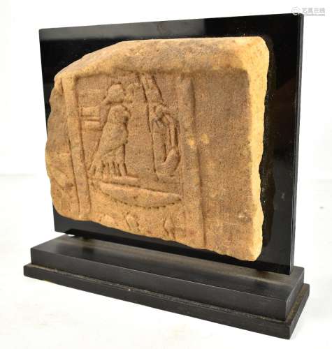 An Egyptian carved sandstone plaque with incised decoration, approx 19 x 22.5cm, now mounted for