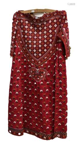 A Central Asian Suzani silk woven ceremonial dress with detailed flowers on a red ground with 'coin'