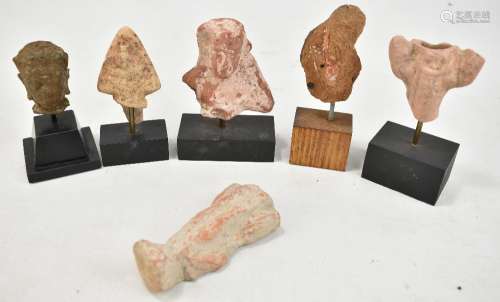 Four small Egyptian carved busts and fragments, also a Roman and a Buddhist example, height of
