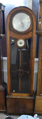 An early 20th century oak cased longcase clock, with arched top, the silver dial with Arabic