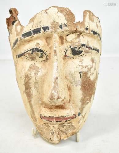 An Egyptian wooden mask with traces of painted decoration, height approx 24cm (af).Additional