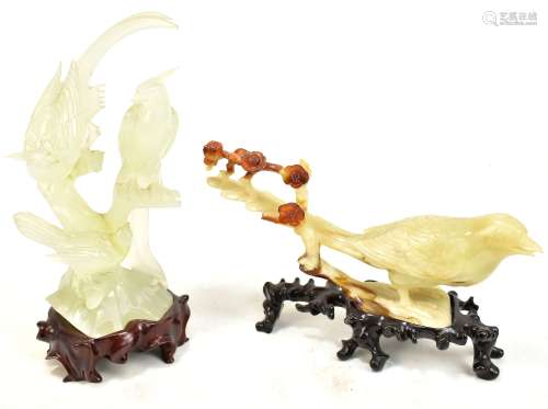A Chinese polished hardstone group of three exotic birds mounted on a carved wooden stand, height
