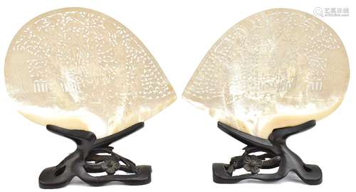 A pair of late 19th/early 20th century Chinese reticulated shells with mirrored scenes featuring