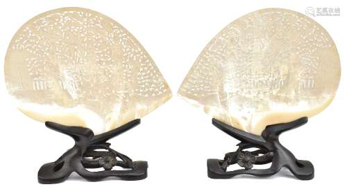 A pair of late 19th/early 20th century Chinese reticulated shells with mirrored scenes featuring