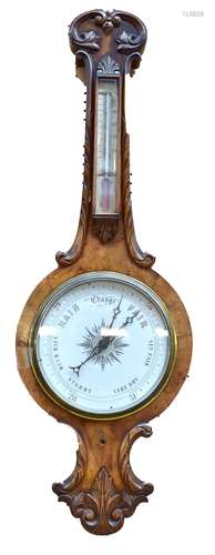 A Victorian walnut banjo barometer with carved detail above white circular dial, height 102cm.