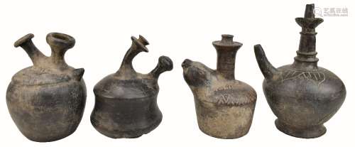 A group of four Attic ware ewers, two with simple bands of incised decoration, the largest 27cm.