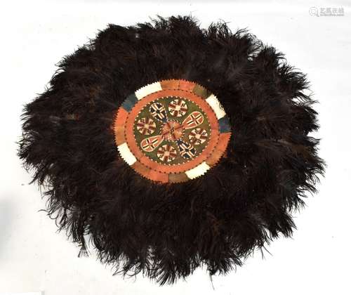 An African ostrich feather and leather circular panel.