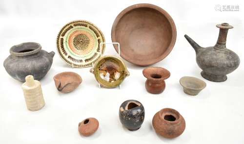 A Cretan black glazed ewer, a simple brown glazed bowl, a fish decorated bowl, etc.Additional