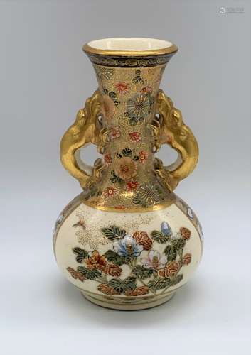 A Japanese Meiji period Satsuma vase with pierced dragon handles, decorated with figures and