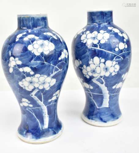 A pair of late 19th/early 20th century Chinese blue and white baluster vases with painted four