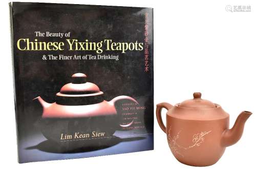 A late 20th century Chinese Yixing teapot with prunus decoration to one side and calligraphy to