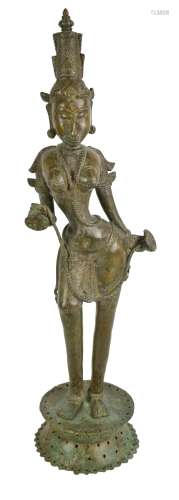 A large 19th century Southeast Asian bronze figure of Tara raised on a pierced shaped circular base,