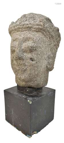 A large Javanese carved volcanic stone bust, height 28cm, now mounted on a wooden plinth.