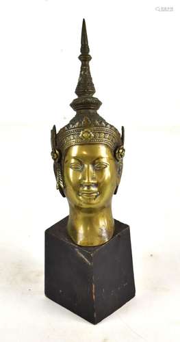 A late 19th century Southeast Asian bronze bust with pronounced spike to the headdress, now