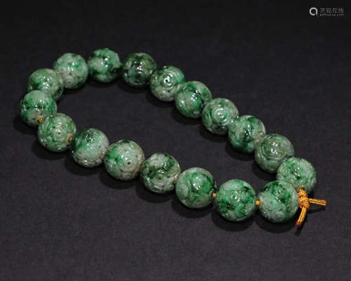 A Qing Dynasty jadeite Flower Patten hand strings