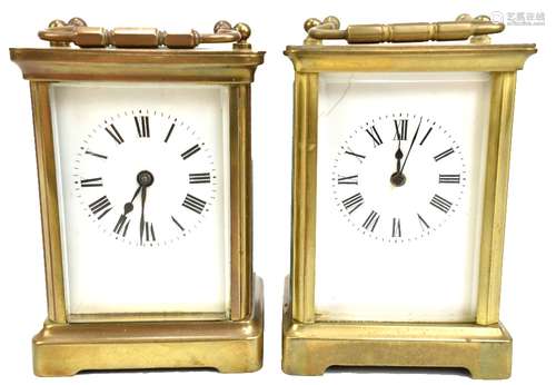 Two early 20th century brass cased carriage clocks, the circular enamel dials set with Roman