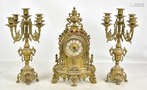 A reproduction gilt metal three piece clock garnature with pierced ornate decoration, the dial