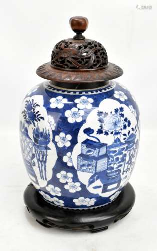 A Chinese blue and white porcelain ginger jar with wooden cover and stand, painted with four