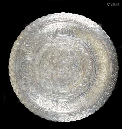 An Eastern white metal circular plate with chased decoration throughout, impressed marks to reverse,