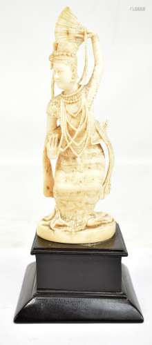 A late 19th/early 20th century Indian carved ivory figure depicting a female dancer holding fan, now