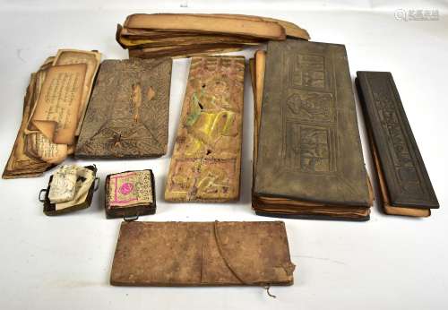 A group of Tibetan prayer scrolls/manuscripts, some with wooden boards, and a further wooden Javan