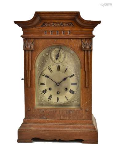 GUSTAV BECKER; an early 20th century oak cased bracket clock with carved decoration surrounding a