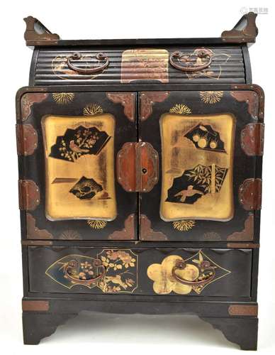 An early 20th century Japanese lacquered jewellery cabinet with central drawer above two panelled