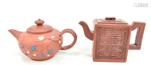 Two Chinese Yixing clay teapots including a rectangular example with embossed symbols, each with