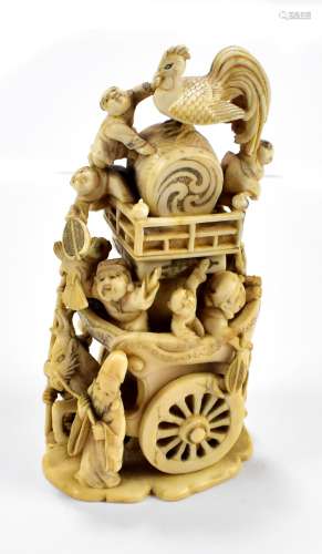 18TH CENTURY TOKYO SCHOOL; a carved ivory okimono depicting a religious procession with mythical