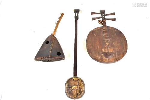 A Indonesian guitar, length 60cm, a Chinese three stringed lute (san hsien), length 87cm, and a