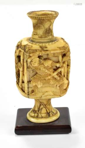 A 19th century Japanese ivory carving in the form of a vase depicting Benkei and Yoshitsuna in the