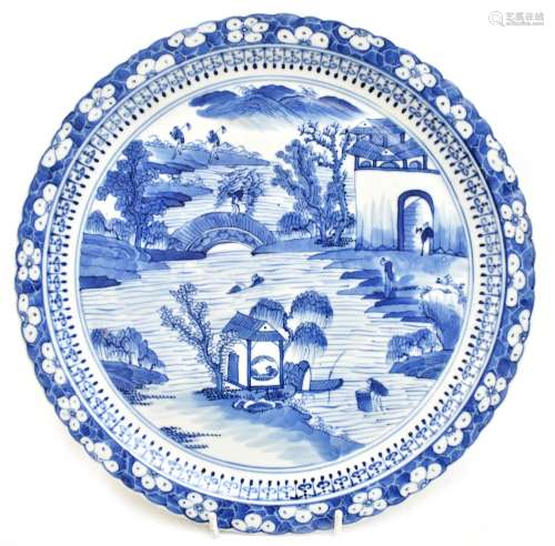 An early 20th century Chinese blue and white porcelain plate with scalloped edge, painted with