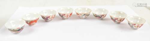 A set of eight 20th century Chinese porcelain miniature tea bowls decorated in enamels with dragon