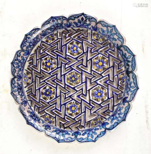 A 19th century Turkish Iznik-style earthenware cobalt glazed reticulated floral motif platter,