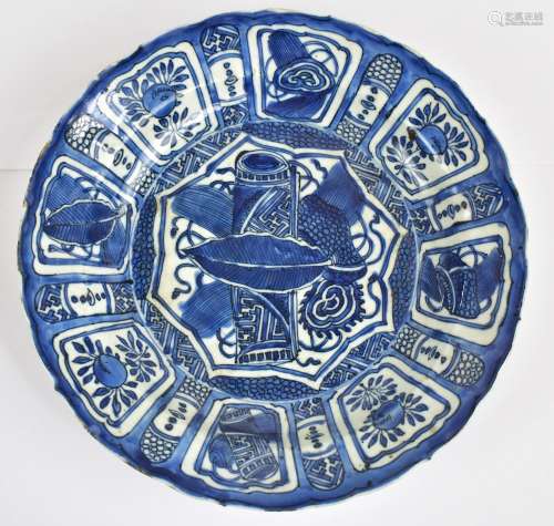 A Chinese late Ming kraak porcelain bowl painted in underglaze blue with typical panel and foliate